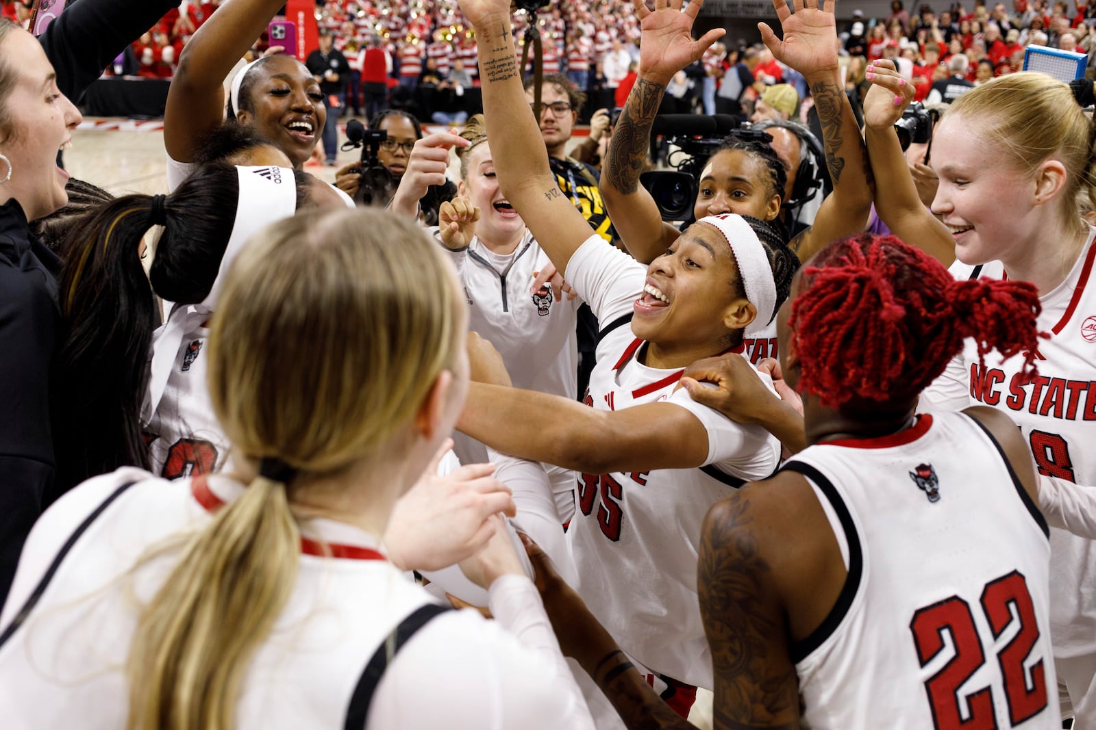 North Carolina State players celebrate after defeating Notre Dame in an NCAA college basketball game in Raleigh, N.C., Sunday, Feb. 23, 2025. (AP Photo/Ben McKeown)