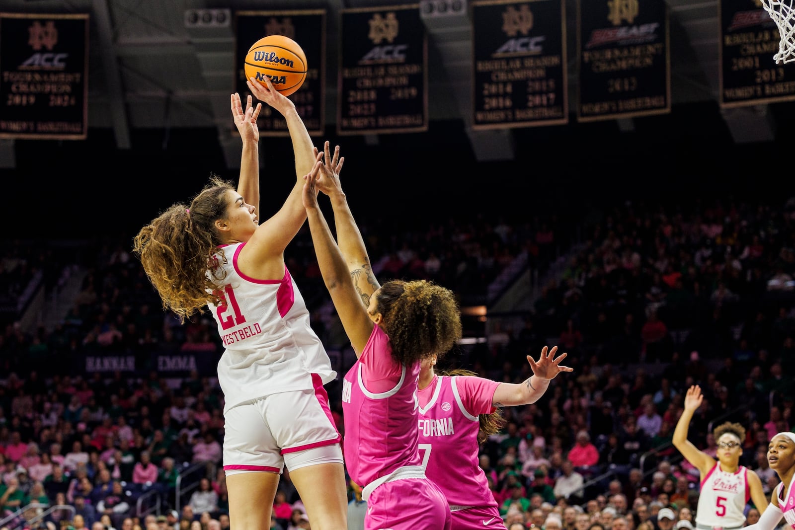 Notre Dame forward Maddy Westbeld (21) shoots as California guard Jayda Noble, centet, defends during the first half of an NCAA college basketball game Sunday, Feb. 9, 2025, in South Bend, Ind. (AP Photo/John Mersits)