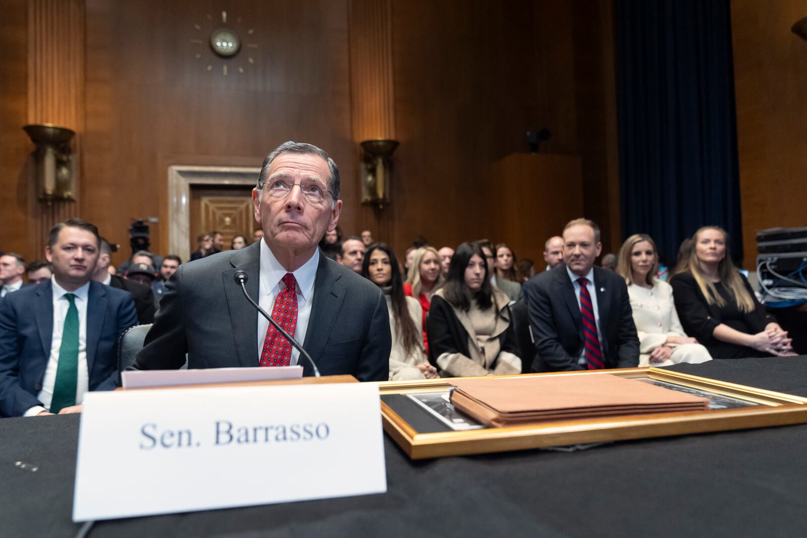 Sen. John Barrasso, R-Wyo., left, prepares to introduce former Rep. Lee Zeldin, R-N.Y., third from right, President-elect Donald Trump's pick to head the Environmental Protection Agency, before a hearing of the Senate Environment and Public Works Committee on Capitol Hill, Thursday, Jan. 16, 2025, in Washington. (AP Photo/Mark Schiefelbein)