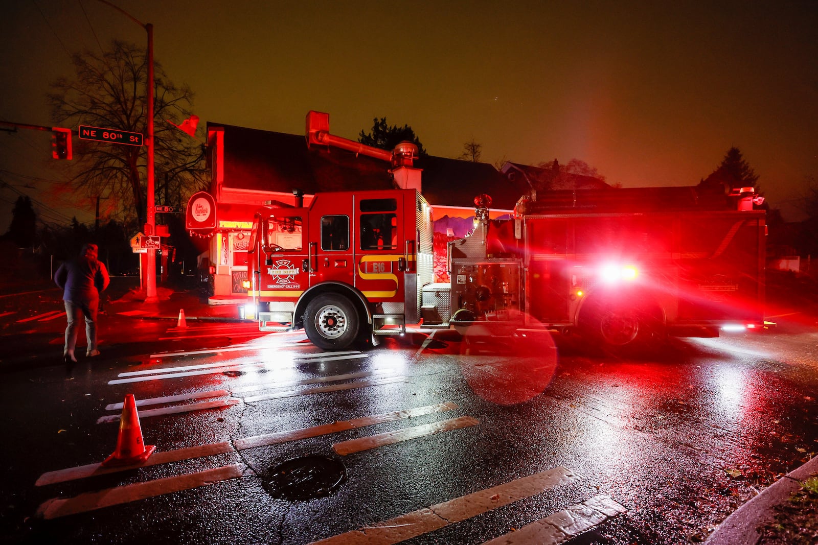 A firetruck blocks NE 80th St. at Roosevelt after power lines fell across the street during a major storm Tuesday, Nov. 19, 2024 in Seattle. (Jennifer Buchanan/The Seattle Times via AP)