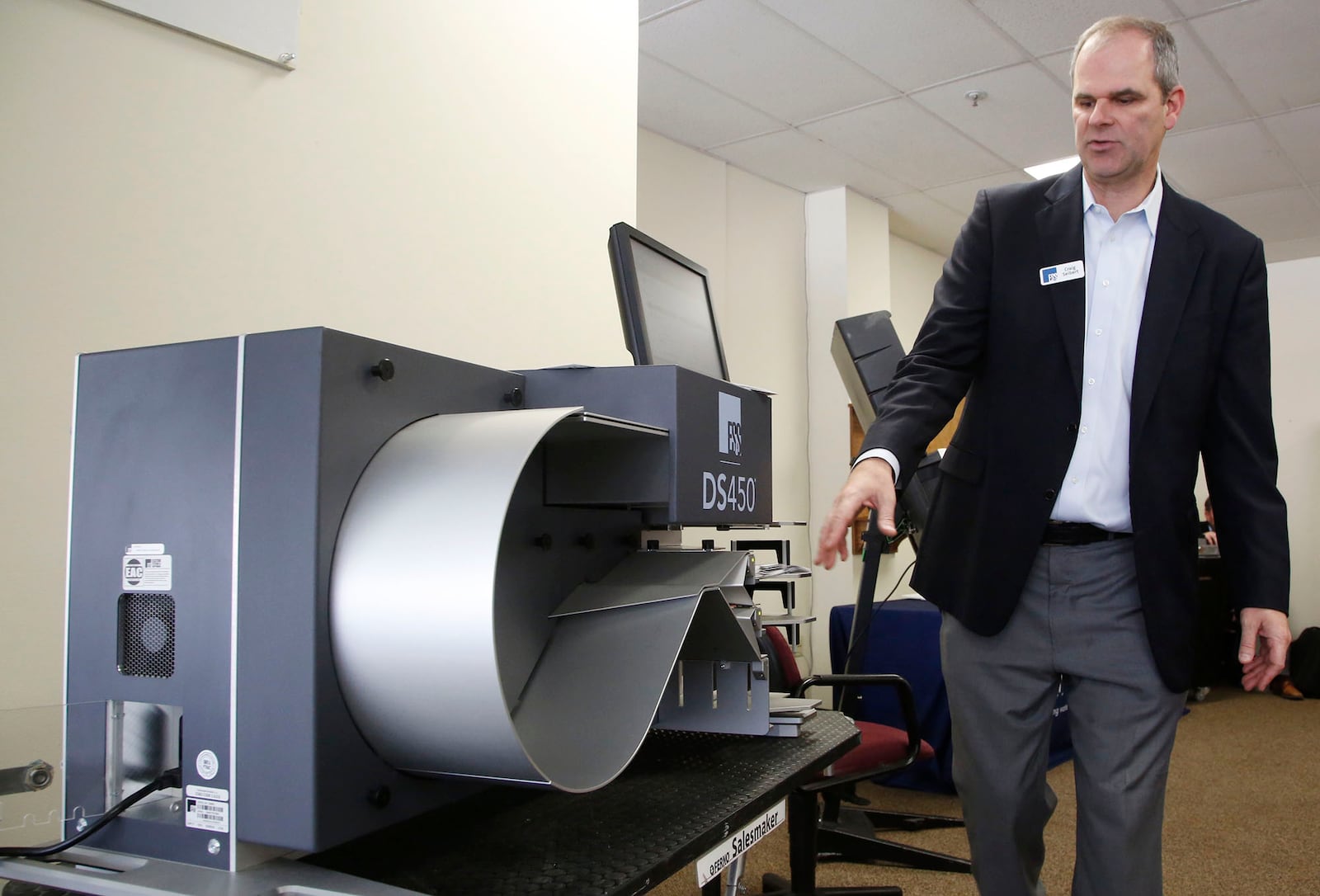 Craig Seibert, regional sales manager, from Election Systems & Software demonstrates a voting machine to the Greene County Board of Elections in Xenia. Dominion Voting Systems machines were demonstrated in a later session.    TY GREENLEES / STAFF