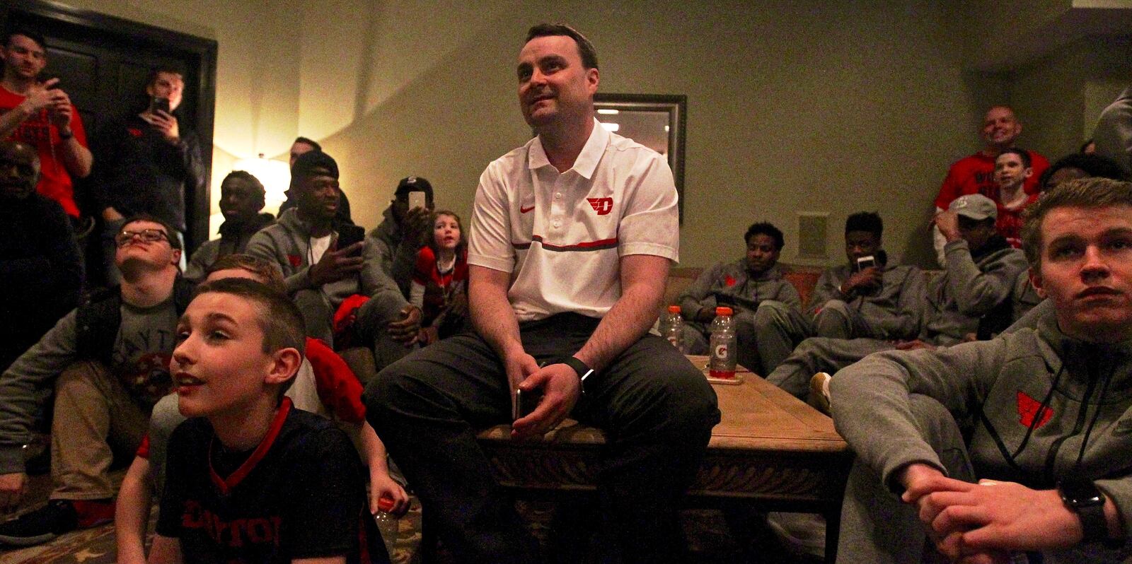 Dayton coach Archie Miller watches the NCAA tournament selection show at his house in Kettering on Sunday, March 12, 2017. David Jablonski/Staff