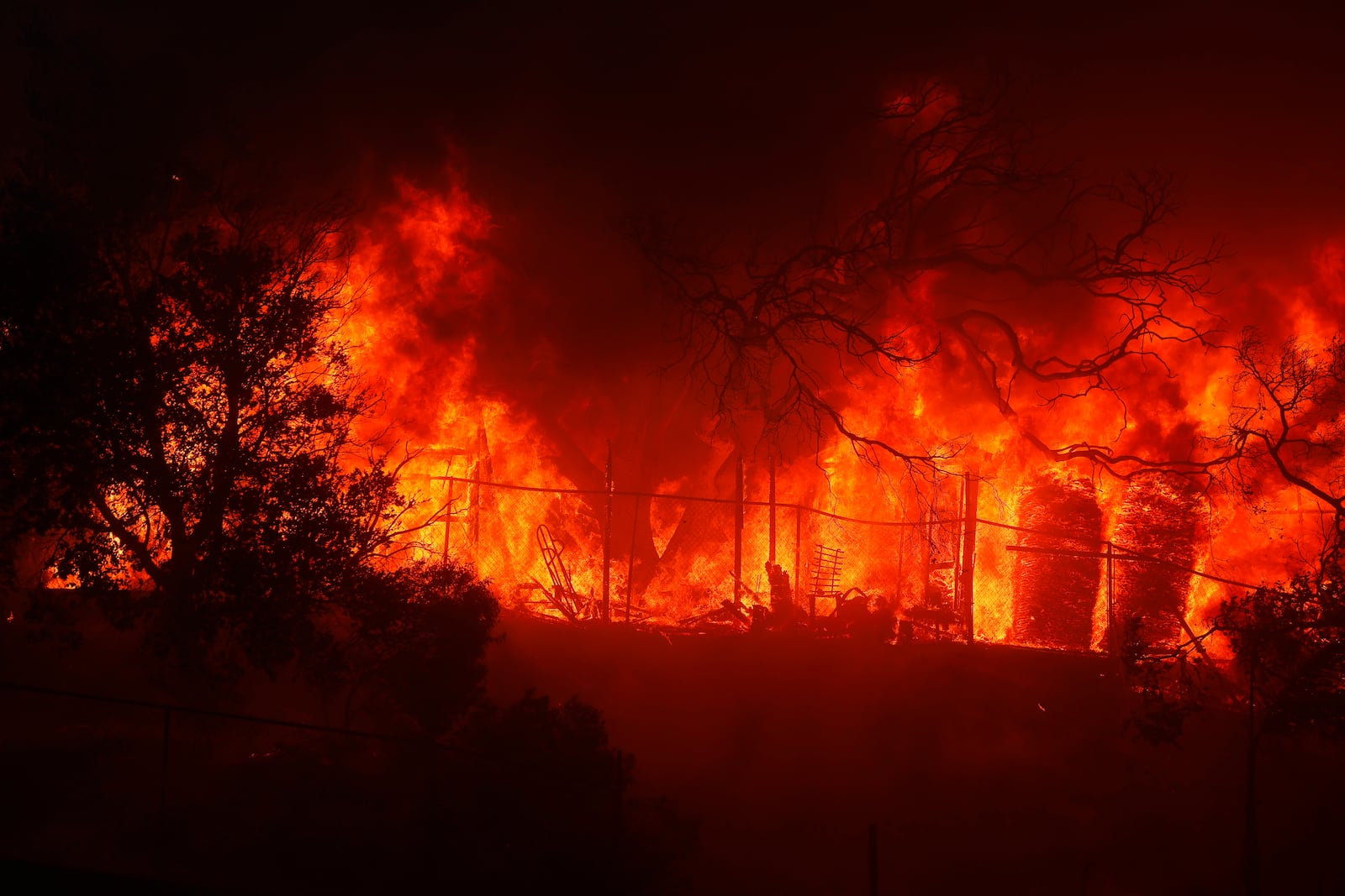 The Palisades Fire burns a property in the Pacific Palisades neighborhood of Los Angeles, Tuesday, Jan. 7, 2025. (AP Photo/Etienne Laurent)