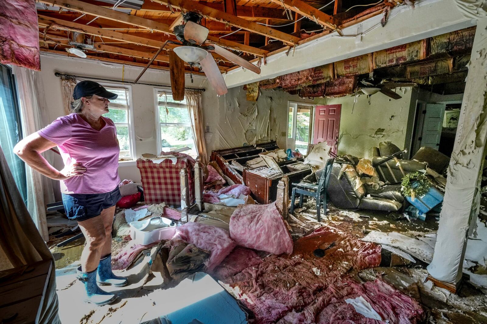 FILE - Cindy White looks over the devastation inside her home caused by Hurricane Helene, Tuesday, Oct. 1, 2024 in Morganton, N.C. (AP Photo/Kathy Kmonicek, File)