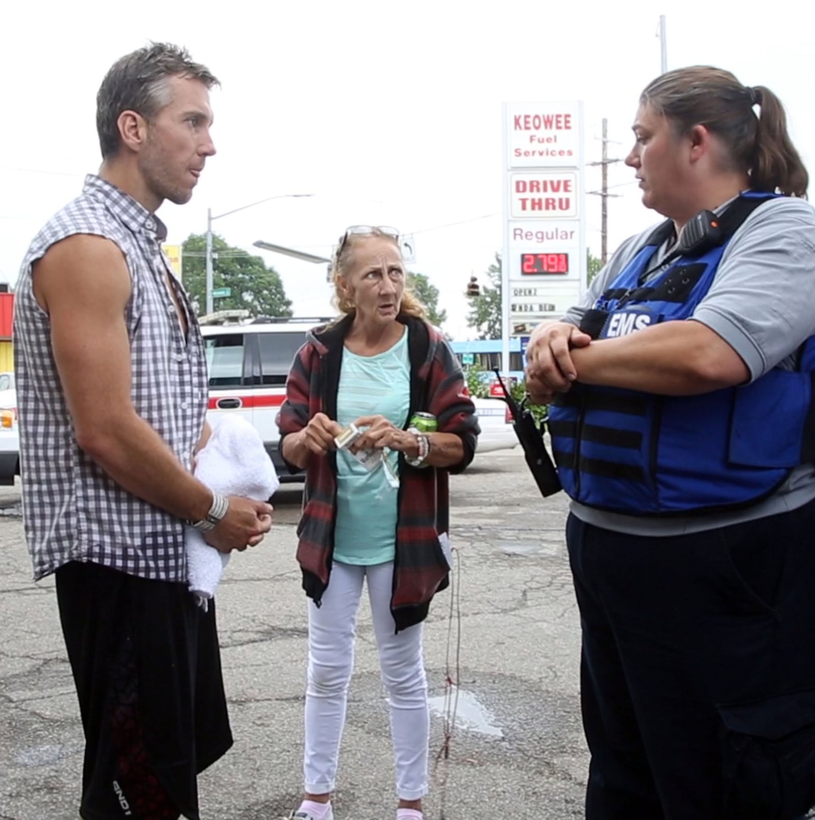 Dayton Fire Department Addiction Resource Liaison/EMT Amy Dunkin, right, listens to a man she had just revived with Narcan at a gas station on North Keowee Street. TY GREENLEES / STAFF