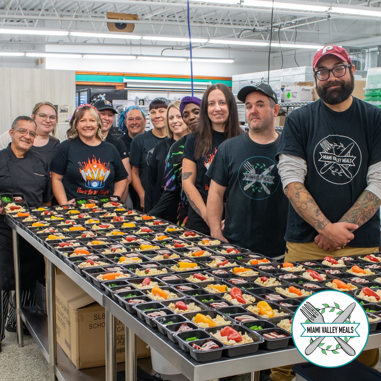 The staff at Miami Valley Meals with meals that they have prepared for distribution.