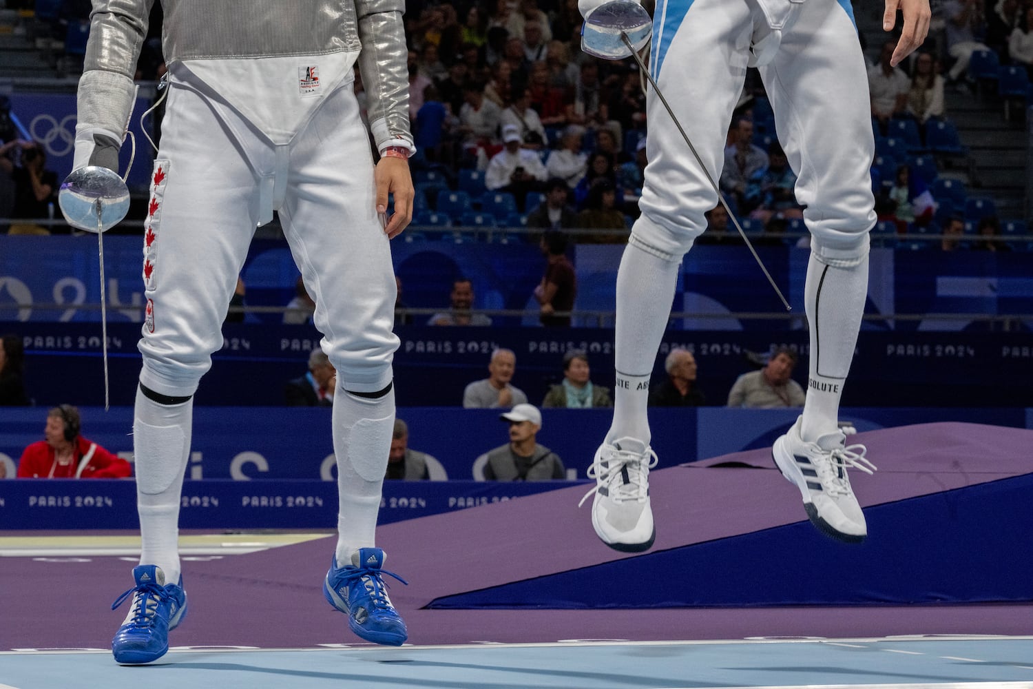 
                        Francois Cauchon of Canada, left, and Pascual Maria di Tella of Argentina do jumping exercises before their Men's Sabre Individual event at the Grand Palais in Paris during the 2024 Summer Olympics on Saturday, July 27, 2024. There are 10,000 athletes at the Paris Games, spread across 32 sports — in the space of 19 days, that field has to be whittled down to just 329 gold medals. (James Hill/The New York Times)
                      