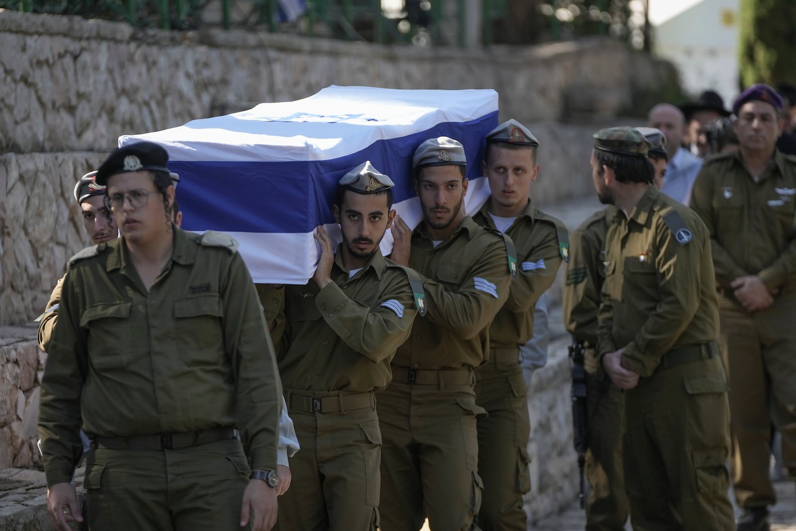 Israeli soldiers carry the coffin of combat engineer squad commander Staff Sgt. Zamir Burke, 20, from Beit Shemesh, during his funeral at Mount Herzl military cemetery in Jerusalem, Israel, Sunday Nov. 1, 2024. Burke was killed in combat with Hamas at the Jabaliya refugee camp in Gaza. (APcPhoto/Mahmoud Illean)