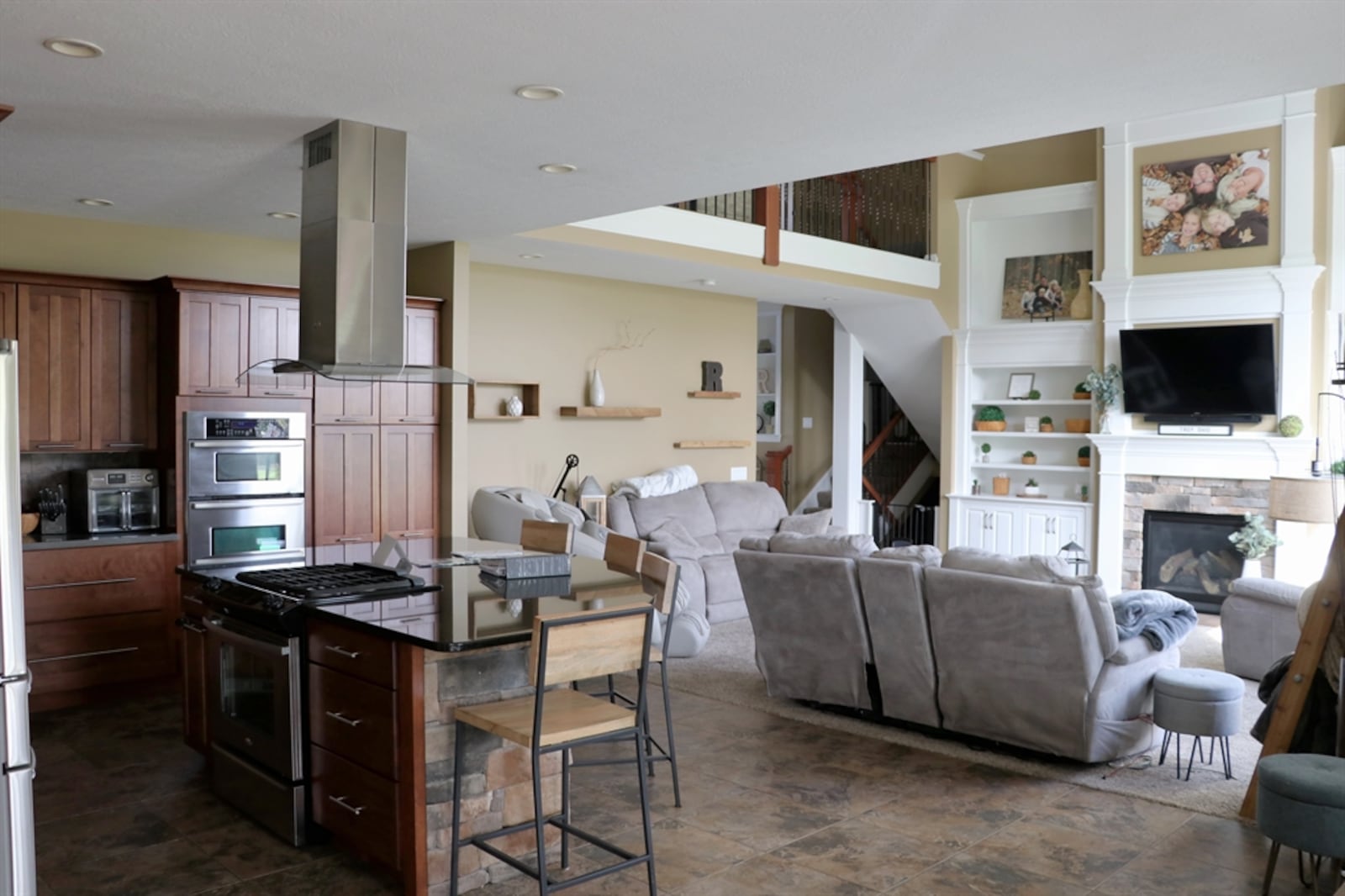 The main level offers a large great room, which opens to the spacious kitchen and dining area. 