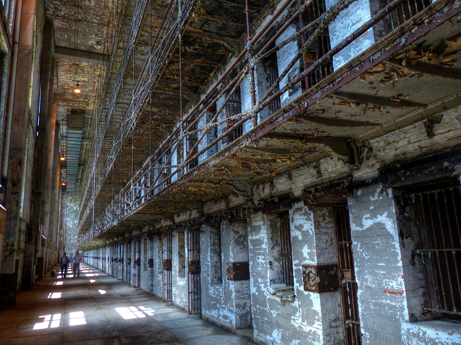 Layers upon layers of peeling paint reveal a glimpse of how the West Tower at the Ohio State Reformatory looked between 1895 and 1990, when more than 155,000 men did time. Visitors can peer into the small jail cells, which were large enough to accommodate a twin-size bed, toilet and small sink.  CONNIE POST/STAFF