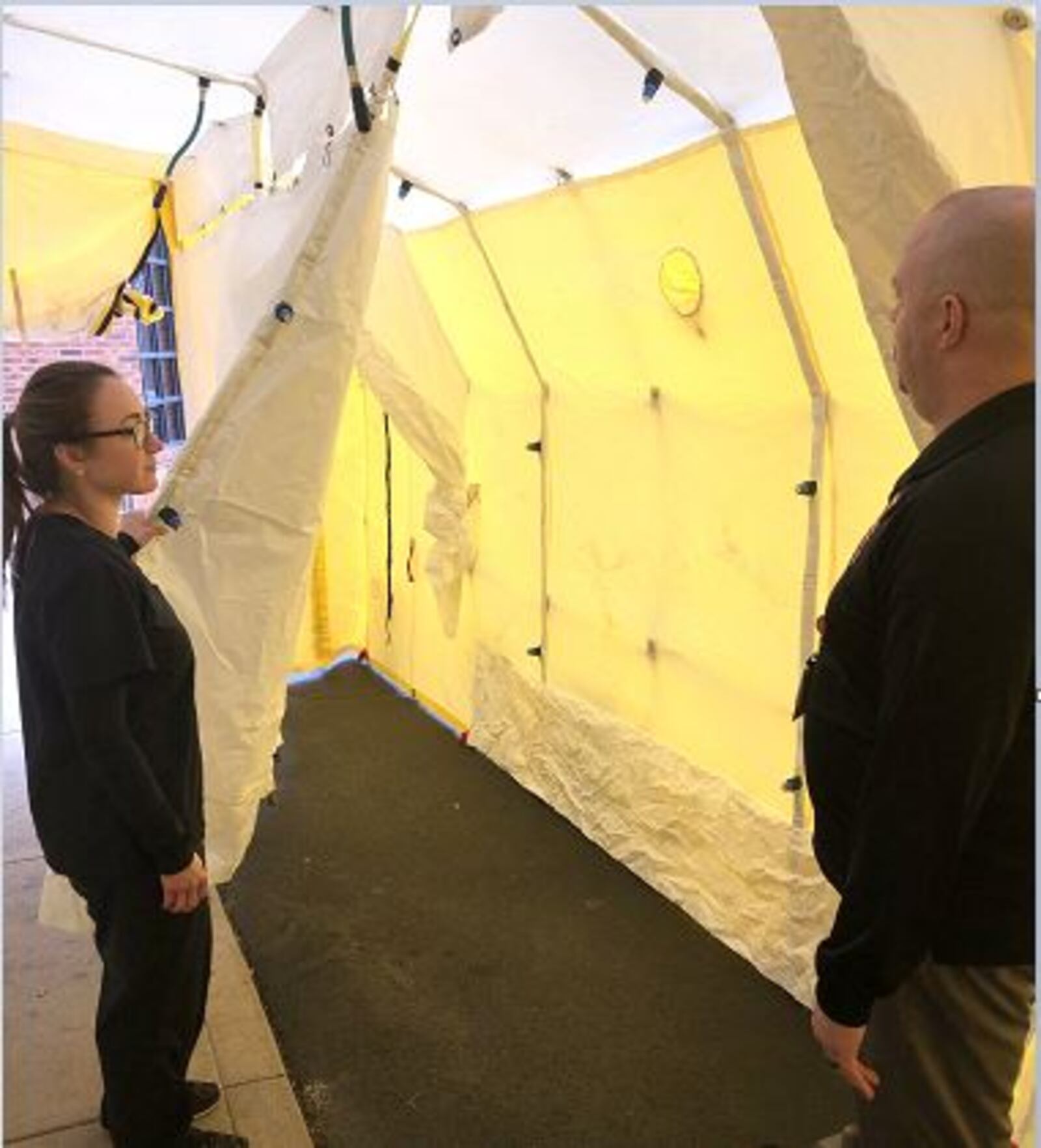 Dr. Melissa Mekesa, medical director of Wilson Health's emergency department/EMS. works with Rich Morrett, EMS and emergency preparedness coordinator, to set up a COVID-19 triage tent Tuesday, March 24, 2020. (Wilson Health)