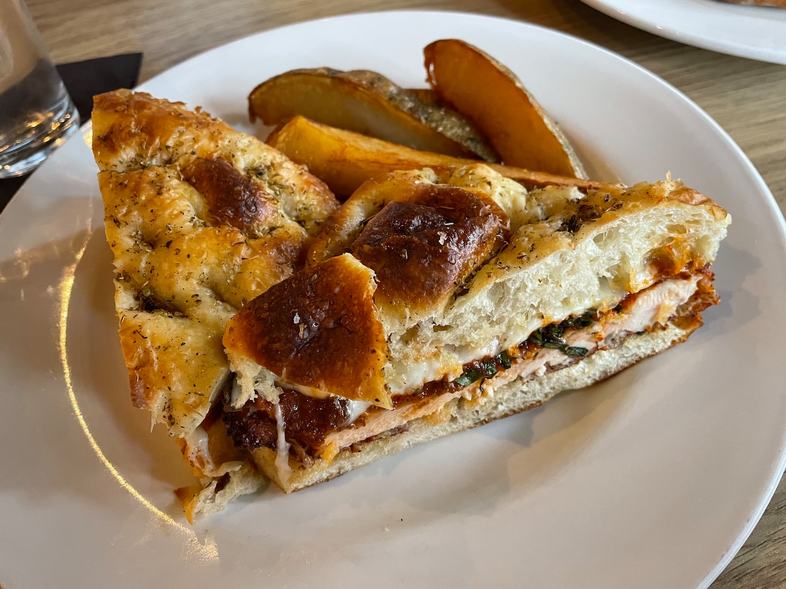 The Chicago Style Chicken Parmesan Sandwich with Jojos from Wheat Penny Oven & Bar on Wayne Ave. in Dayton. NATALIE JONES/STAFF