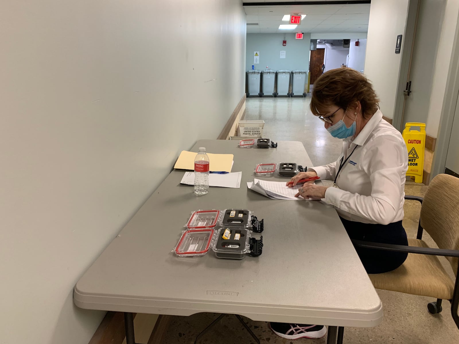 Montgomery County Board of Elections Director Jan Kelly logs USB cards containing vote tallies as they are delivered to the board of elections for counting.