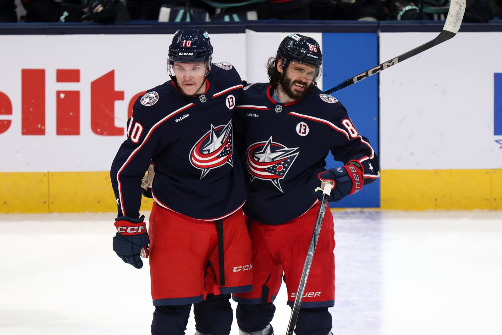 Columbus Blue Jackets forward Kirill Marchenko, right, celebrates his empty-net goal against the Seattle Kraken with teammate forward Dmitri Voronkov, left, during the third period of an NHL hockey game in Columbus, Ohio, Thursday, Jan. 9, 2025. (AP Photo/Paul Vernon)