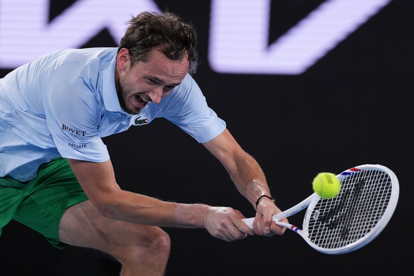 Daniil Medvedev of Russia plays a backhand return to Learner Tien of the U.S. during their second round match at the Australian Open tennis championship in Melbourne, Australia, Thursday, Jan. 16, 2025. (AP Photo/Ng Han Guan)