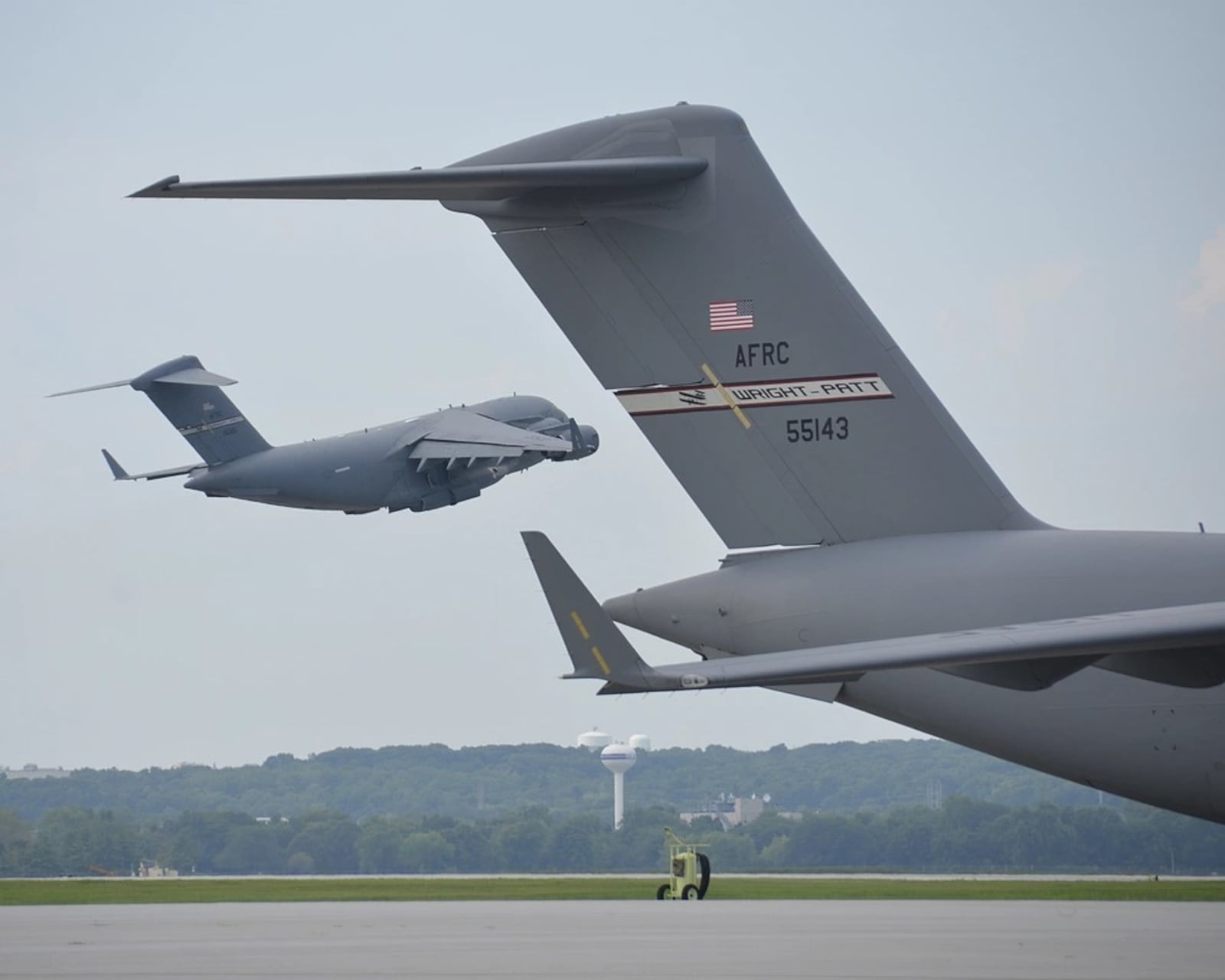 A C-17 Globemaster III aircraft takes off from a runway on August 15, 2020, at Wright Patterson Air Force Base. This particular C-17 is part of the 445th Airlift Wing, home to nine C-17s and nearly 2,000 Reserve Citizen Airmen. (U.S. Air Force photo by Staff Sgt. Ethan G. Spickler)