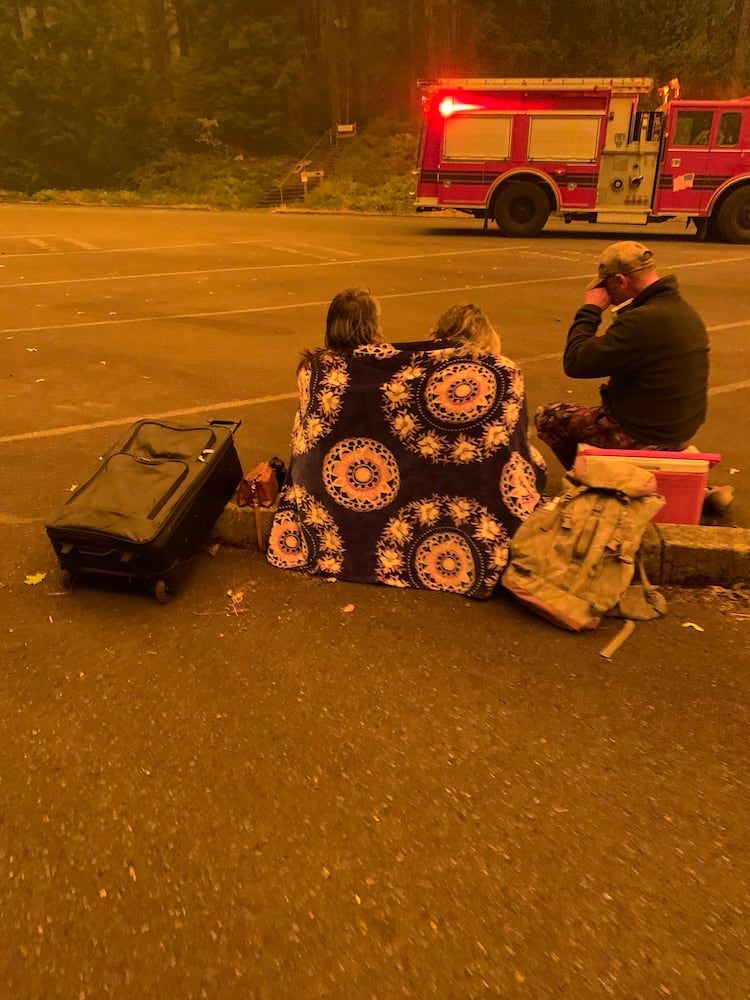 *EMBARGO: No electronic distribution, Web posting or street sales before THURSDAY 3:01 a.m. ET SEPT. 17, 2020. No exceptions for any reasons. EMBARGO set by source.**An image provided by Cindy Neblett, evacuees amidst the fire in Detroit, Ore. After raging wildfires left them trapped on the shores of a reservoir near Detroit, Ore., dozens of people and nine firefighters mounted a last stand, hoping for a miracle. (Cindy Neblett via The New York Times)-- NO SALES; FOR EDITORIAL USE ONLY WITH NYT STORY ORE-WILDFIRES-ESCAPE BY JACK HEALY AND MIKE BAKER FOR SEPT. 16, 2020. ALL OTHER USE PROHIBITED. --