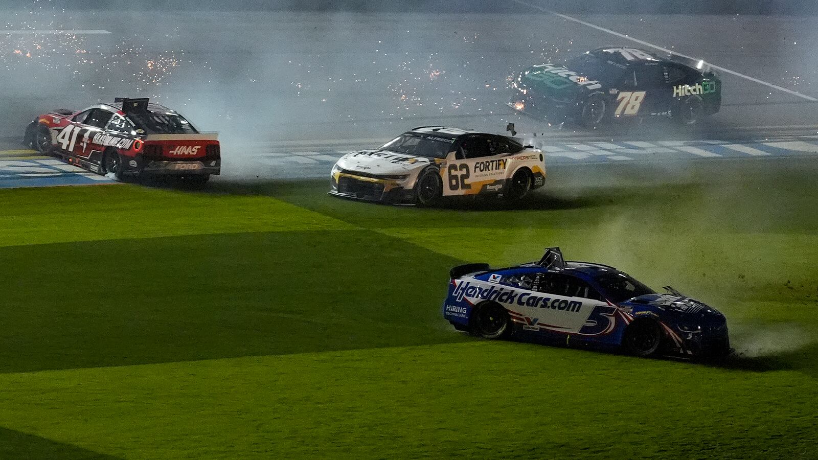 Kyle Larson (5), Cole Custer (41), Anthony Alfredo (62), and BJ McLeod (78) crash during the second of two NASCAR Daytona 500 qualifying auto races Thursday, Feb. 13, 2025, at Daytona International Speedway in Daytona Beach, Fla. (AP Photo/Chris O'Meara)