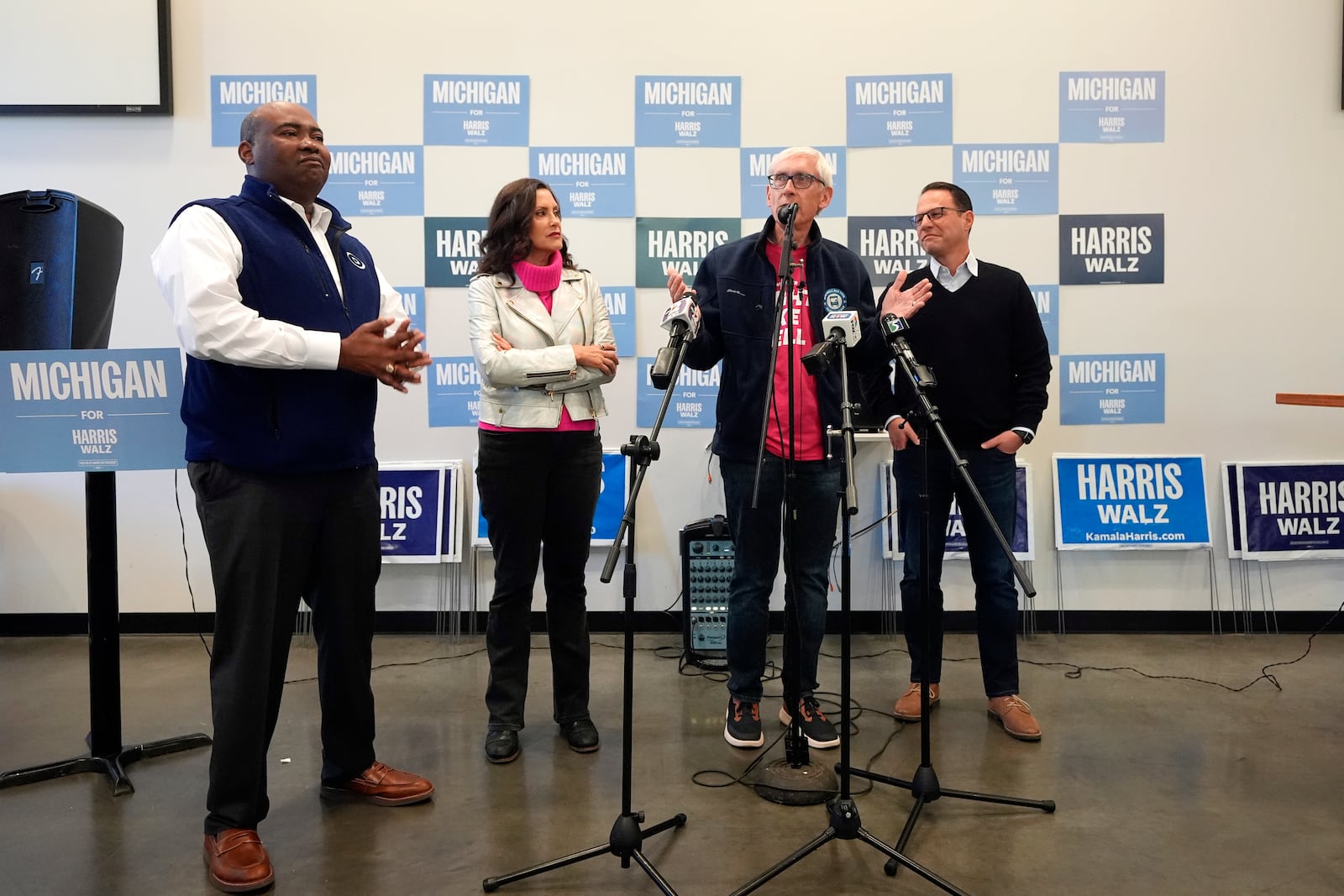 Chair of the Democratic National Committee Jaime Harrison, left, Michigan Gov. Gretchen Whitmer, Wisconsin Gov. Tony Evers and Pennsylvania Gov. Josh Shapiro talk to volunteers during a campaign event, Thursday, Oct. 17, 2024, in Flint, Mich. (AP Photo/Carlos Osorio)