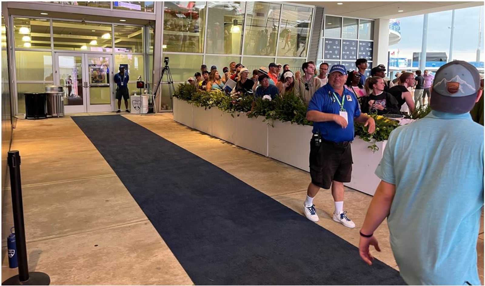 Tennis fans line up waiting for tennis players to exit the Western & Southern Open facility so they can get player autographs. The match on Center Court was still in progress as fans patiently lined up. ED RICHTER/STAFF