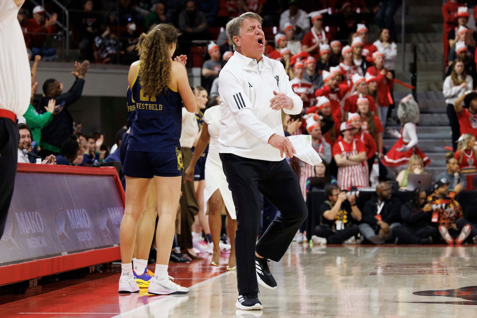 North Carolina State head coach Wes Moore, center, reacts after a call during the second half of an NCAA college basketball game against Notre Dame in Raleigh, N.C., Sunday, Feb. 23, 2025. (AP Photo/Ben McKeown)