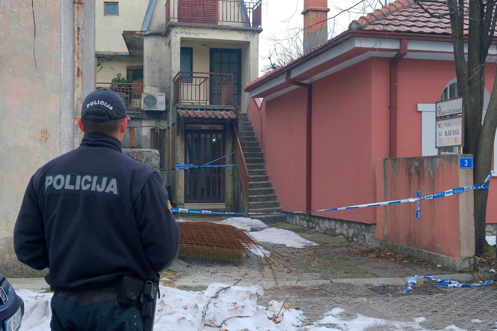 A police officer stands guard at the scene after a shooting incident at a bar, in Cetinje, 36 kilometers (22 miles) west of Podogrica, Montenegro, Thursday, Jan. 2, 2025. (AP Photo/Risto Bozovic)