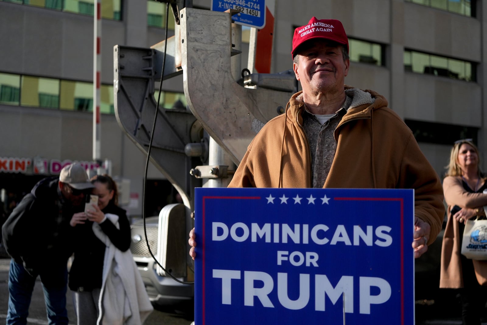 A Dominican supporter of Donald Trump poses outside a Trump rally in Reading, Pa., Monday, November 4. (AP Photo/Luis Andres Henao).