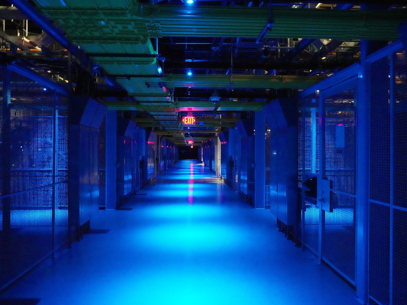 Blue lights illuminate an aisle at a data center in San Jose, Calif., on Feb. 23, 2024. Data center growth continues, amid a ravenous appetite for electricity to power the boom in artificial intelligence. (Jim Wilson/The New York Times)