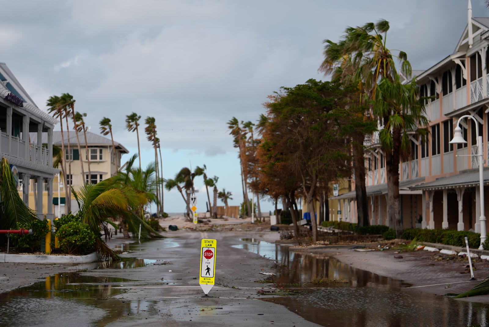 Some standing water lies on Bridge Street after the passage of Hurricane Milton, in Bradenton Beach on Anna Maria Island, Fla., Thursday, Oct. 10, 2024. (AP Photo/Rebecca Blackwell)