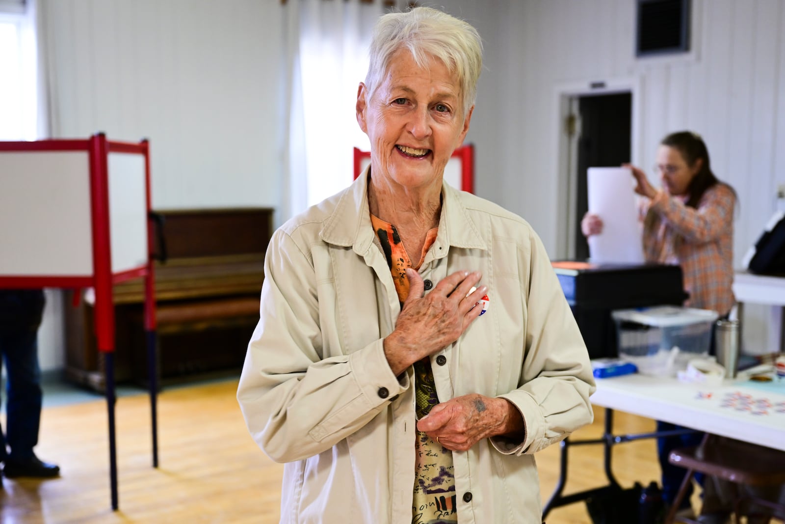 Karen DesRosier places an "I Voted" sticker on her chest after casting a ballot at the Drummond Community Hall in Drummond, Mont., on Election Day, Tuesday, Nov. 5, 2024. (AP Photo/Tommy Martino)