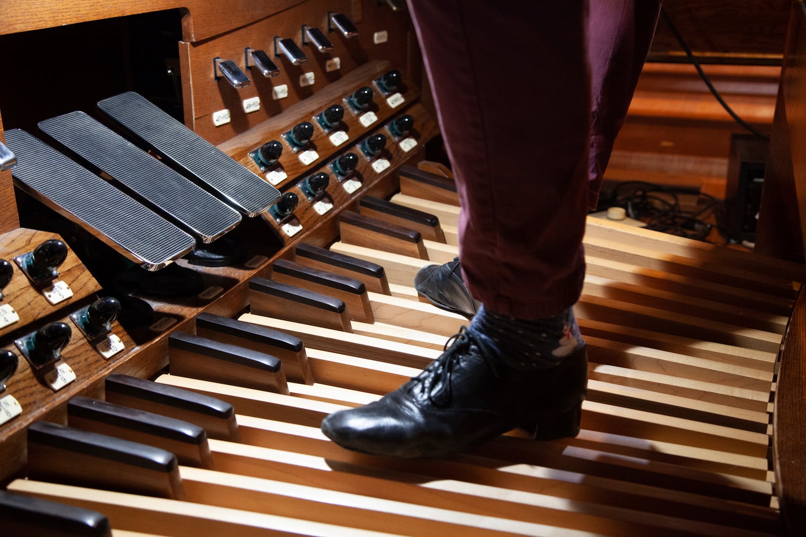 Wearing custom, form-fitting shoes, Colin MacKnight demonstrates how his feet alone can play the organ at the Trinity Episcopal Cathedral in downtown Little Rock, Ark., Tuesday, Jan. 21, 2025. (AP Photo/Katie Adkins)