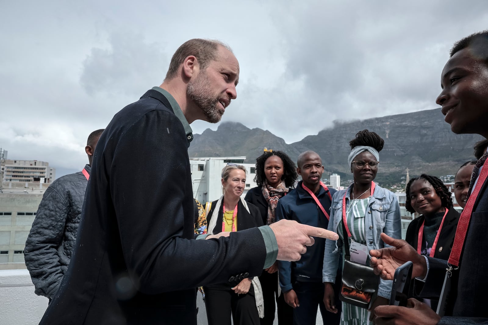 Britain's Prince William, speaks to a group of young people, with Table Mountain in the background at the Earthshot Prize Climate Leaders Youth Programme at Rooftop on Bree in Cape Town, South Africa, Monday Nov. 4, 2024. (Gianluigi Guercia/Pool Photo via AP)