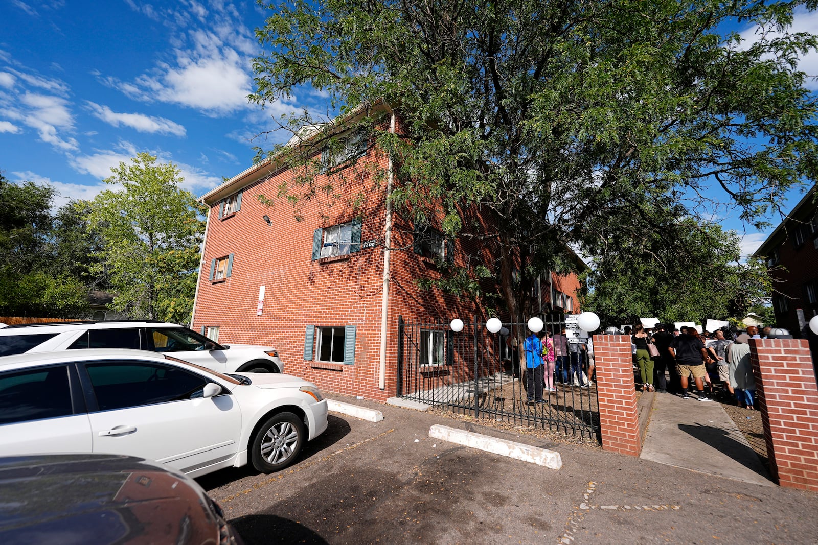 FILE - A rally in the courtyard is staged by the East Colfax Community Collective to address chronic problems in the apartment buildings occupied by people displaced from their home countries in central and South America Tuesday, Sept. 3, 2024, in Aurora, Colo. (AP Photo/David Zalubowski, File)