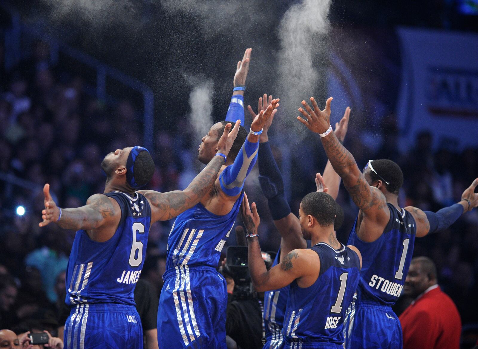 FILE - East team member imitate LeBron James, left, of the Miami Heat, by throwing powder into the air before the NBA basketball All-Star Game on Sunday, Feb. 20, 2011, in Los Angeles. (AP Photo/Mark J. Terrill, File)