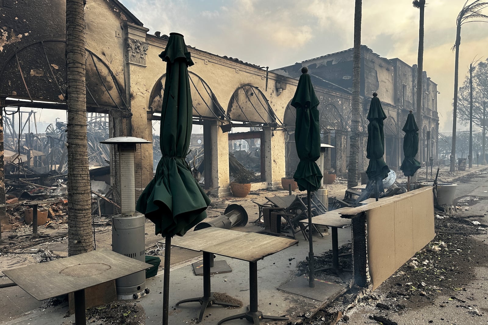 Fire ravaged businesses are seen after the Palisades Fire swept though in the Pacific Palisades neighborhood of Los Angeles, Wednesday, Jan. 8, 2025. (AP Photo/Eugene Carcia)