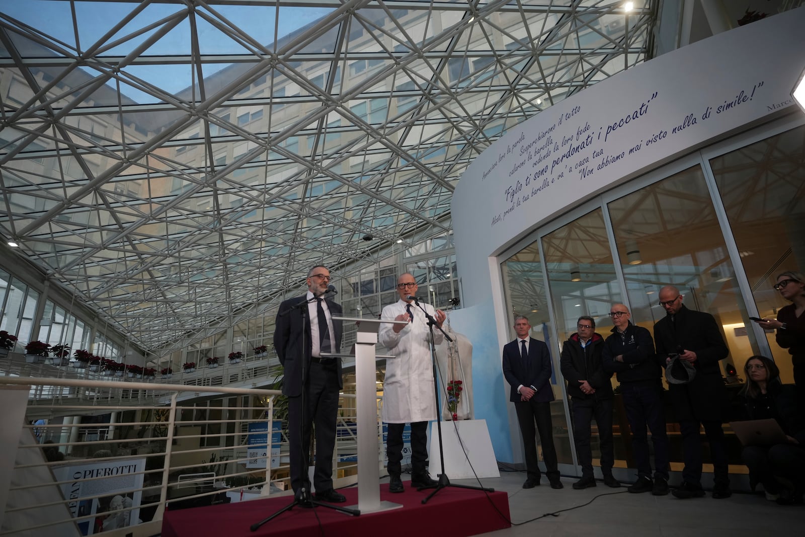 Surgeon Sergio Alfieri, right, and head physician of the Vatican's health and hygiene office, Luigi Carbone speak to journalists, Friday, Feb. 21, 2025, in the entrance hall of Rome's Agostino Gemelli Polyclinic where Pope Francis is being treated for pneumonia. (AP Photo/Alessandra Tarantino)