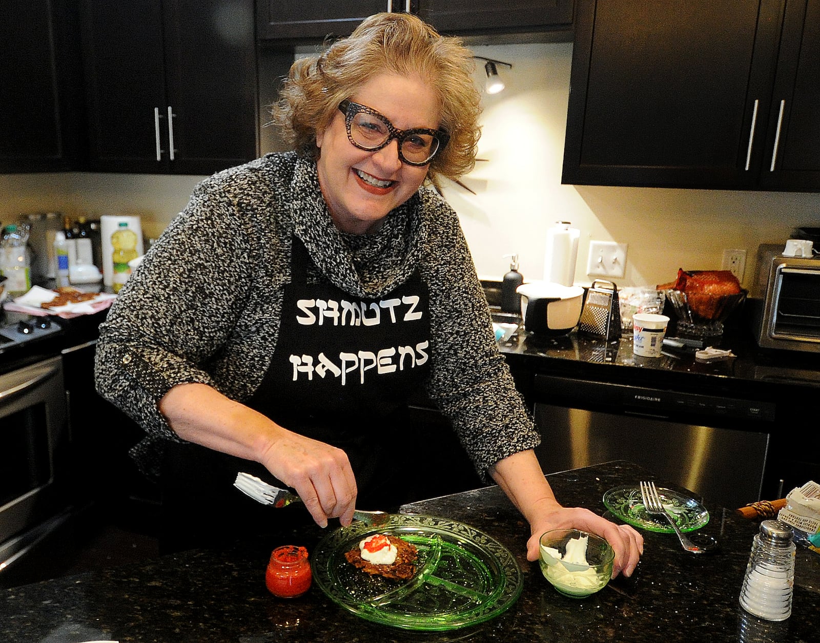 Cathy Gardner in her kitchen preparing latkes at her home in Beavercreek Tuesday. Latkes is a traditional food for Hanukkah. MARSHALL GORBY\STAFF