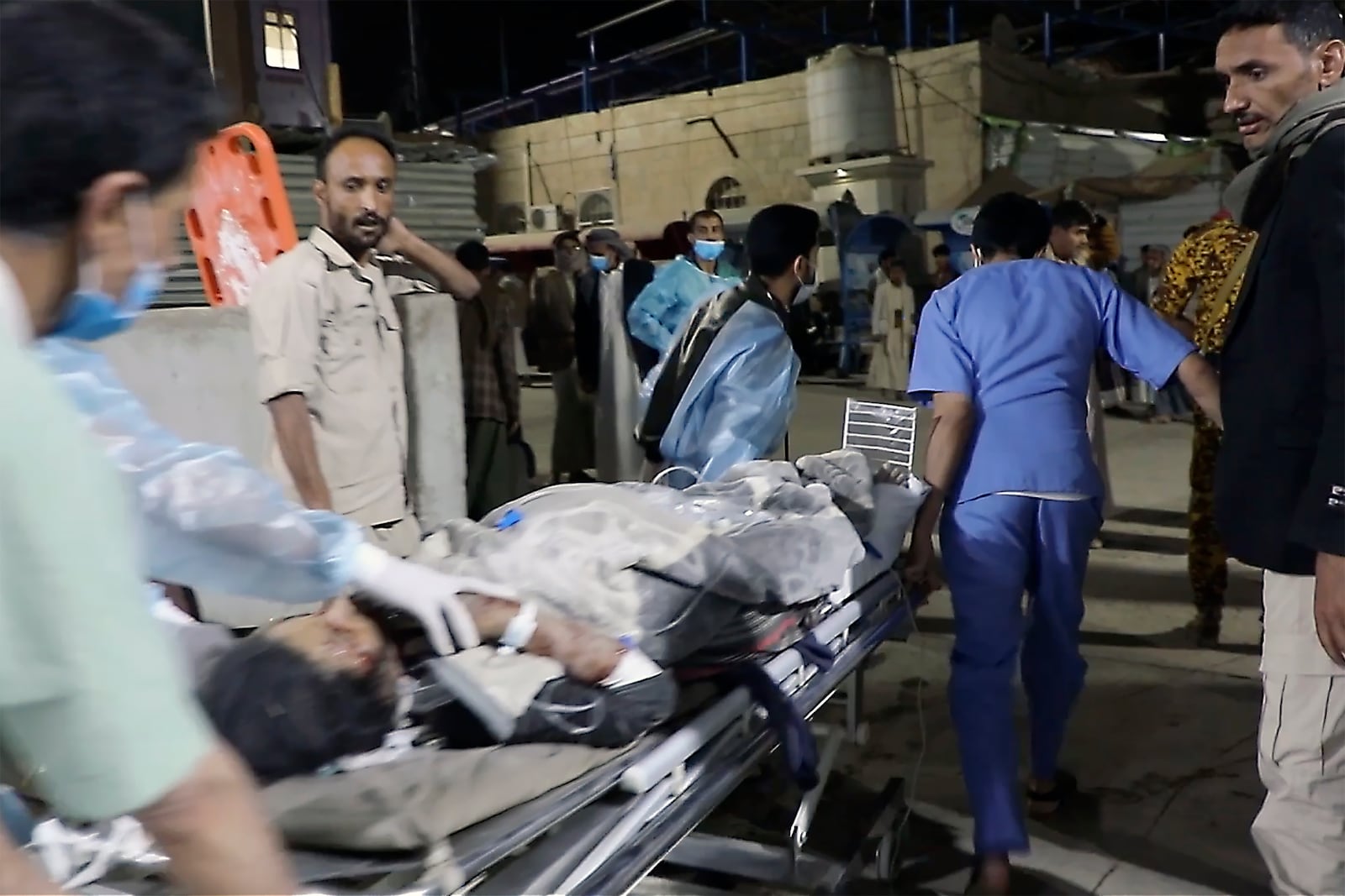 In this photo taken from video released by Ansar Allah Media Office via Al Masirah TV channel shows a being taken for treatment at a hospital in Saada, Yemen, Saturday, March 15, 2025 following airstrikes over multiple targets in the country. The Houthi-run Health Ministry said the overnight strikes killed at least 31 people, including women and children, and wounded over 100 in the capital of Sanaa and the northern province of Saada, the rebels' stronghold on the border with Saudi Arabia.( Al Masirah TV via AP)