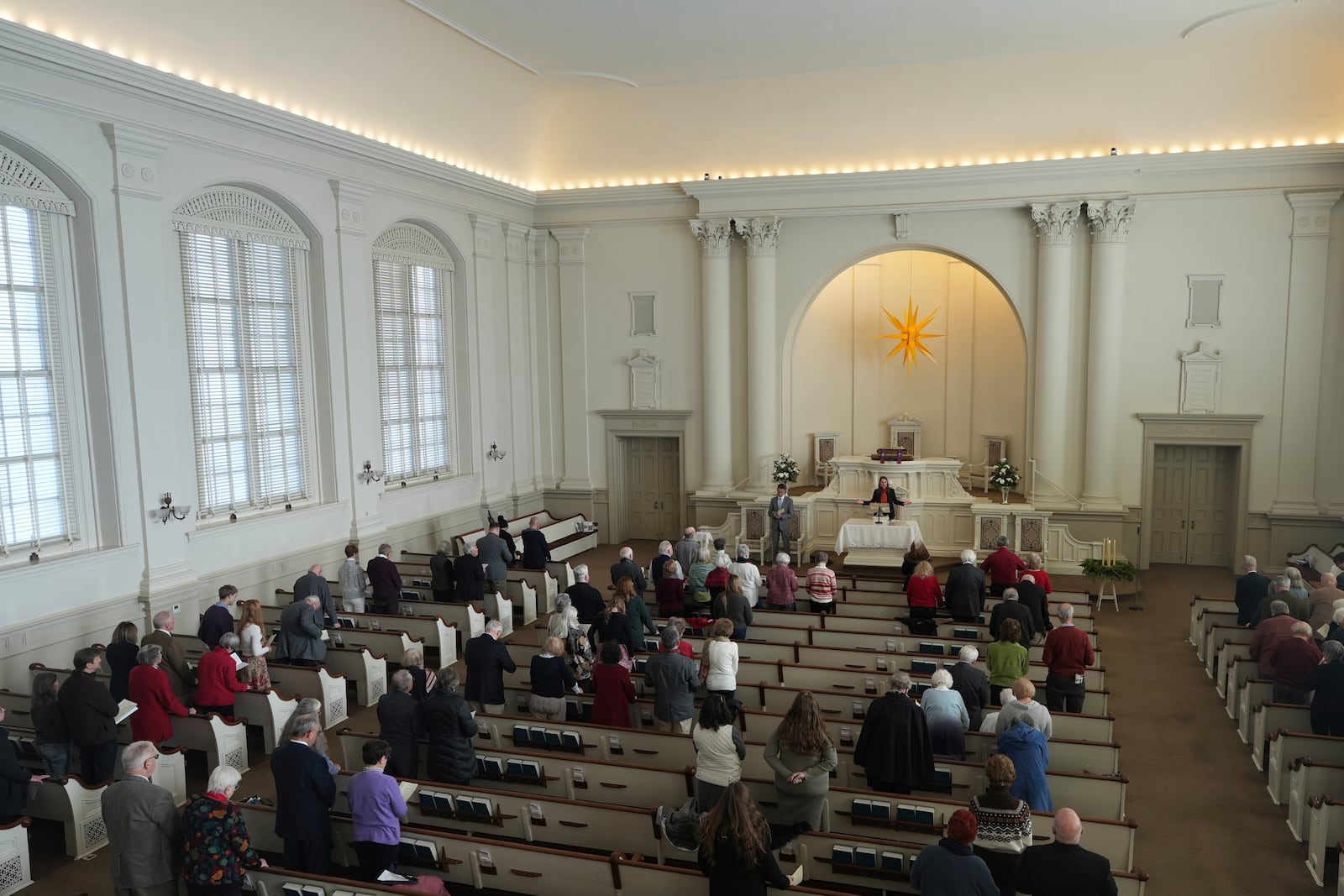 The Rev. Janel Rice, senior pastor of Central Moravian Church, speaks to her congregation during a “Lovefeast” service in Bethlehem, Pa., on Sunday, Dec. 1, 2024. (AP Photo/Luis Andres Henao)