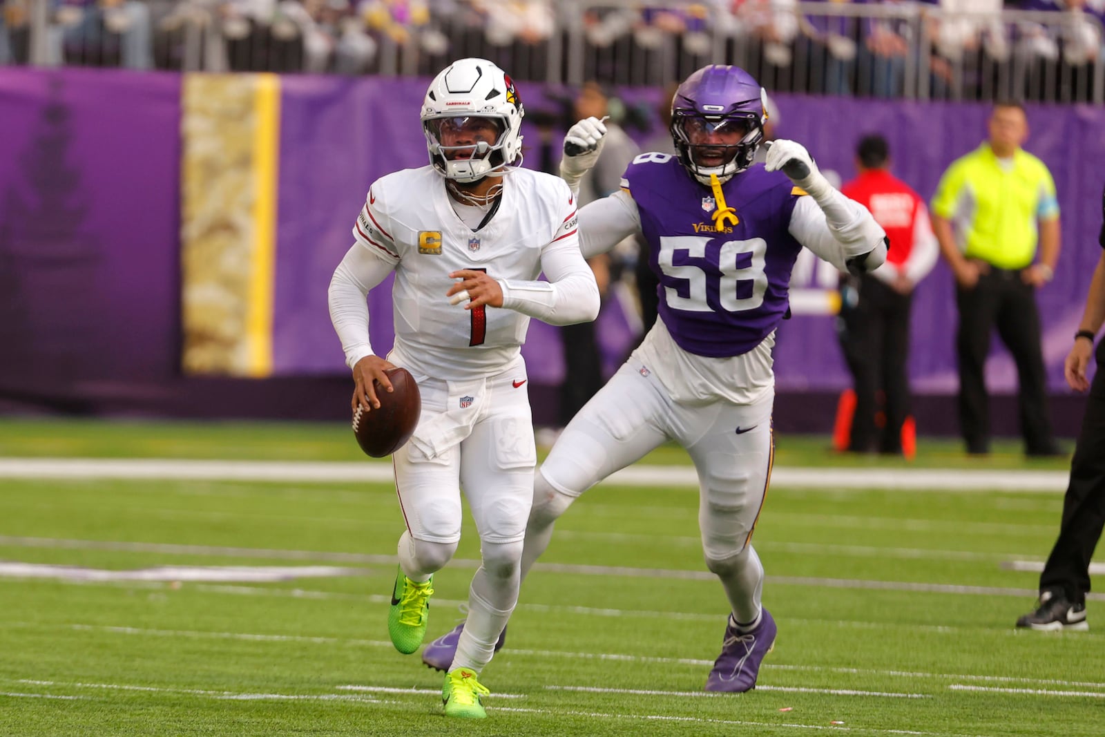 Arizona Cardinals quarterback Kyler Murray (1) runs from Minnesota Vikings linebacker Jonathan Greenard (58) during the first half of an NFL football game Sunday, Dec. 1, 2024, in Minneapolis. (AP Photo/Bruce Kluckhohn)