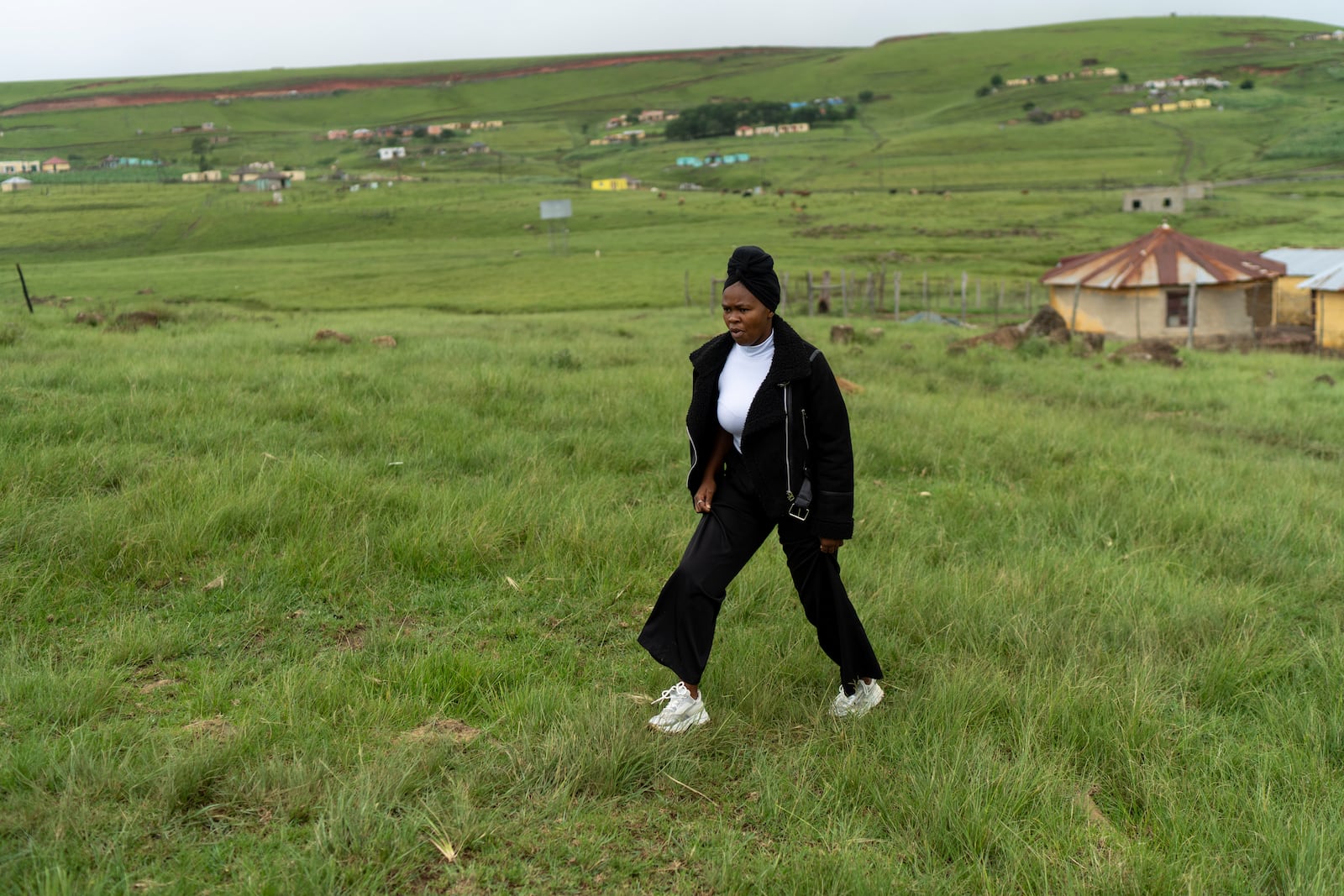 Unemployed 19-year-old South African Nozuko Majola, walking towards her Umzimkhulu home Tuesday, Nov. 11, 2025, is one of millions of patients in South Africa affected by U.S. President Donald Trump's global foreign aid freeze, raising worries about HIV patients defaulting on treatment. (AP Photo/Jerome Delay}