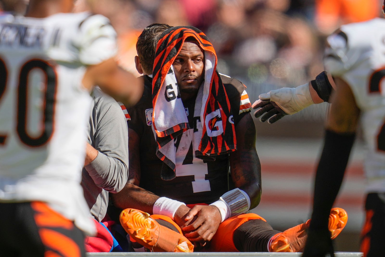 Cleveland Browns quarterback Deshaun Watson (4) is carted off the field after being injured in the first half of an NFL football game against the Cincinnati Bengals, Sunday, Oct. 20, 2024, in Cleveland. (AP Photo/Sue Ogrocki)