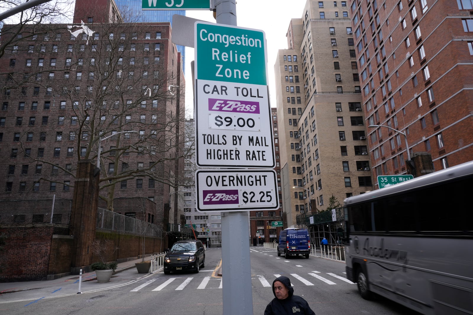 Signs advising drivers of congestion pricing tolls are displayed near the exit of the Lincoln Tunnel in New York, Wednesday, Feb. 19, 2025. (AP Photo/Seth Wenig)