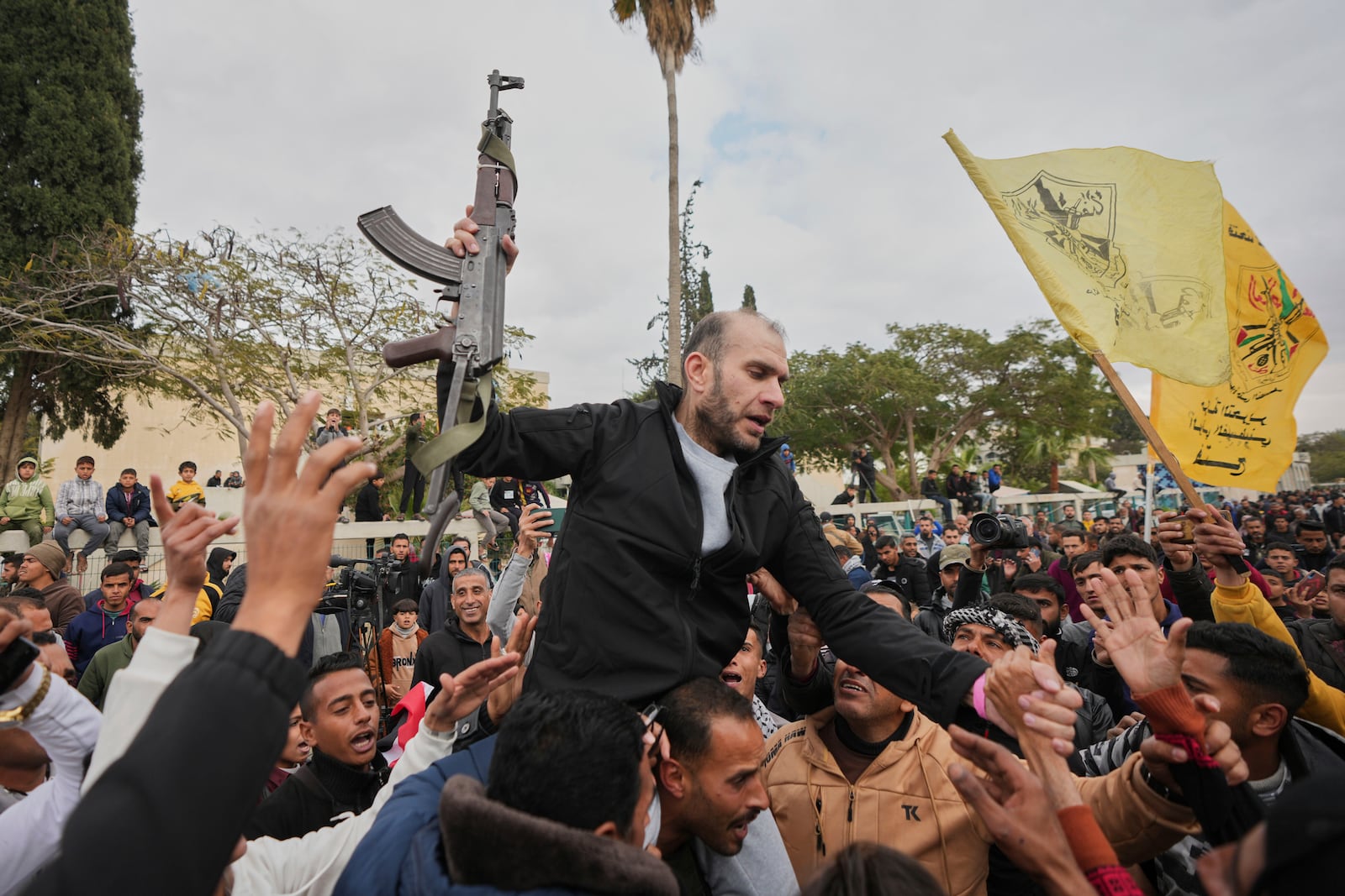 Freed Palestinian prisoners are greeted by a crowd as they arrive in the Gaza Strip after being released from an Israeli prison following a ceasefire agreement between Hamas and Israel in Khan Younis, souther Gaza Strip, Saturday Feb. 8, 2025. (AP Photo/Abdel Kareem Hana)