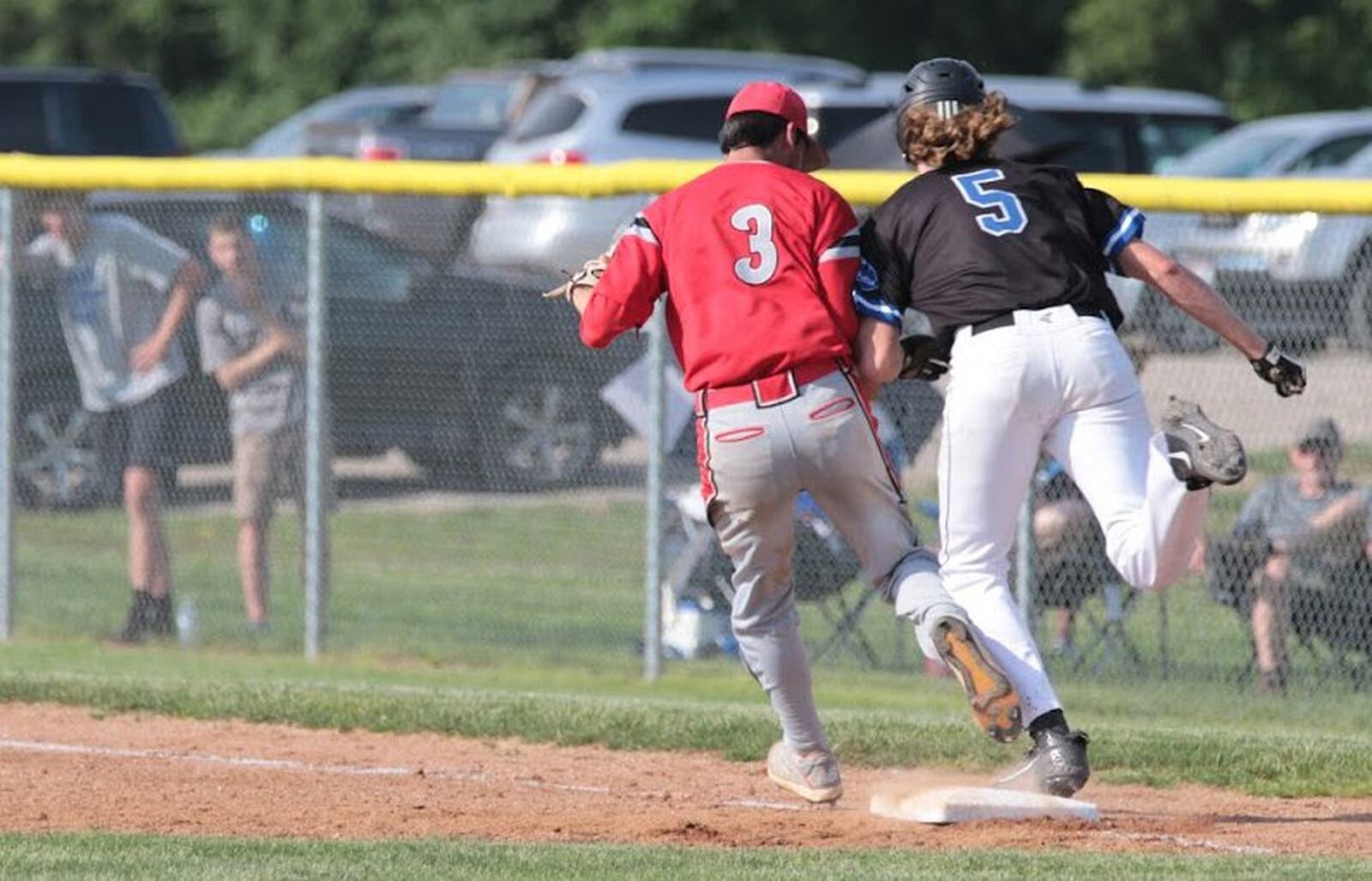 Cincinnati Christian’s Jacob Carroll (5) is out at first base as Tri-County North’s Collin Whipp barely gets there first Friday during a Division IV district baseball final at Carlisle. CCS won 3-1. PHOTO BY KRAE/WWW.KRAEPHOTOGRAPHY.COM