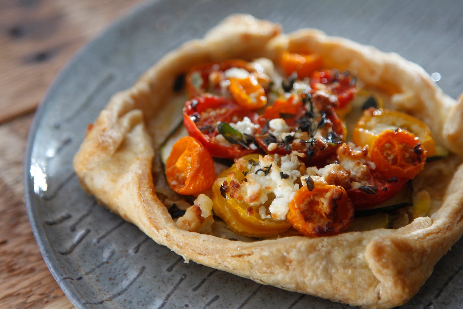 A zucchini, tomato and feta tart from St. Anne the Tart, a new bakery and coffee house in Dayton's St. Anne's Hill historic neighborhood. LISA POWELL / STAFF