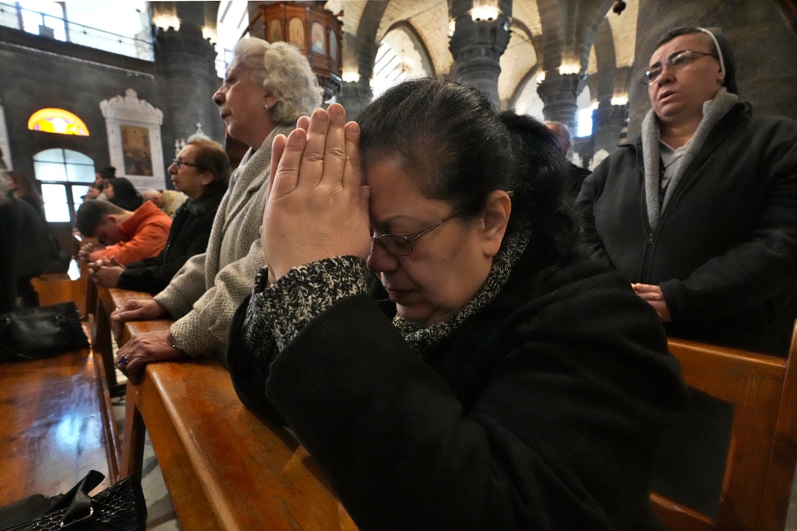 Syrian Christians attend the first Sunday Mass since Syrian President Bashar Assad's ouster, at Mariamiya Orthodox Church in old Damascus, Syria, Sunday, Dec. 15, 2024. (AP Photo/Hussein Malla)