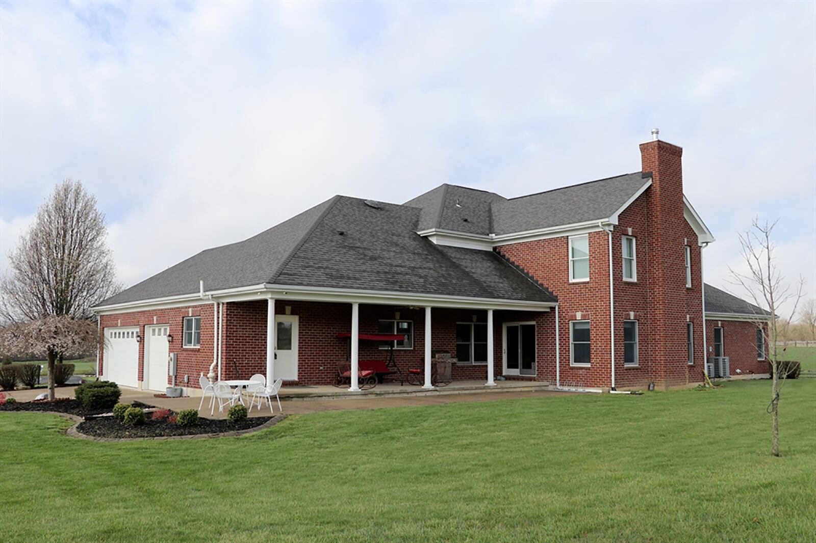 Sliding patio doors open from the great room to the covered rear porch and sun patio. The house, which offers about 4,340 sq. ft. of living space, has a 3-car garage and 2 acres of woods in back. CONTRIBUTED PHOTO