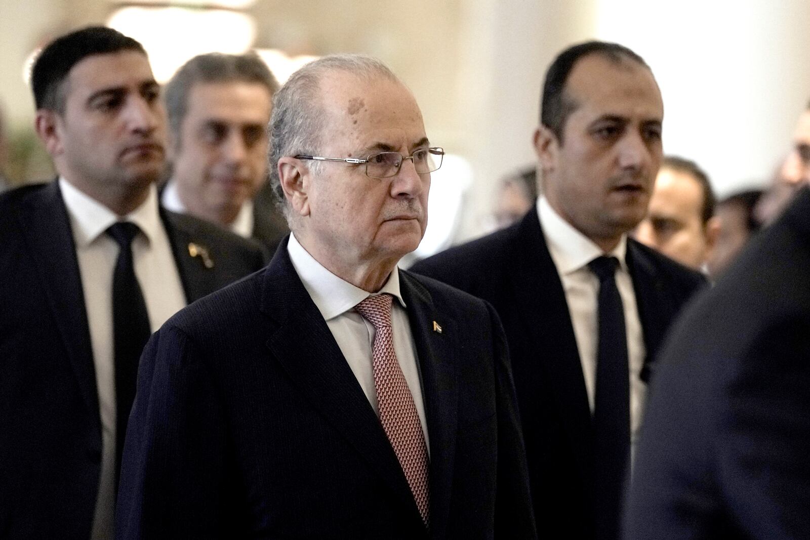 Palestinian Prime Minister Mohammed Mustafa is surrounded by bodyguards during his arrival to meet with Egyptian Foreign Minister Badr Abdelatty, in Cairo, Egypt, Wednesday, Feb. 5, 2025. (AP Photo/Amr Nabil)