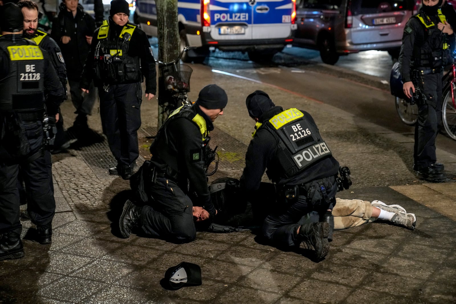 Police officers detain a man at the Holocaust memorial in Berlin, Germany, after another man was seriously injured, Friday, Feb. 21, 2025. (AP Photo/Ebrahim Noroozi)